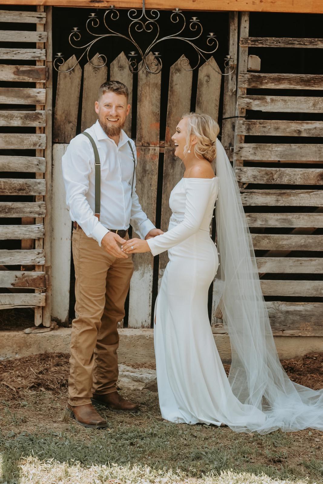 Photo of Ashley and Nolen Dale in front of the Barn at Hayes House