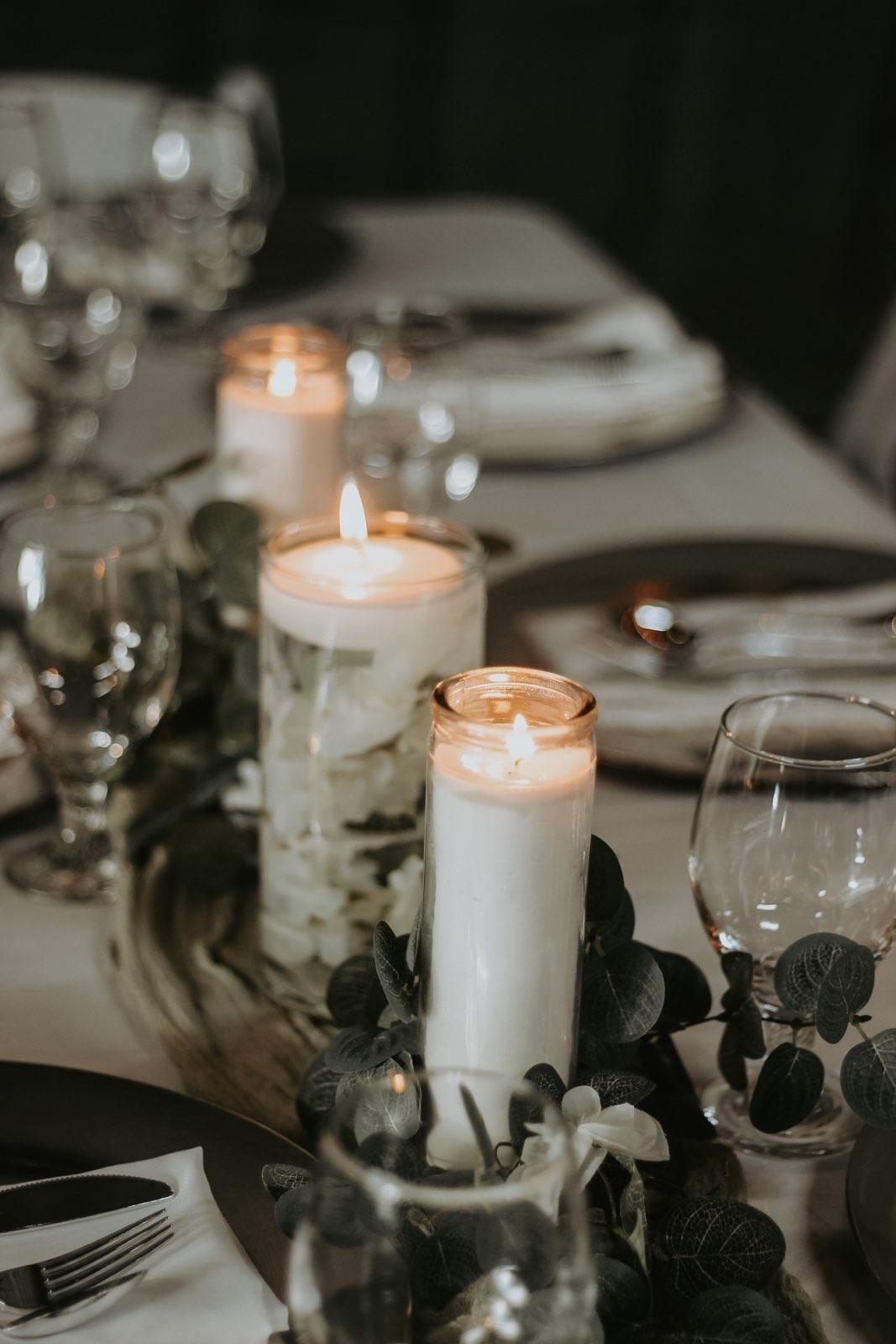 Ashley and Nolen Dale wedding place settings and candles at reception