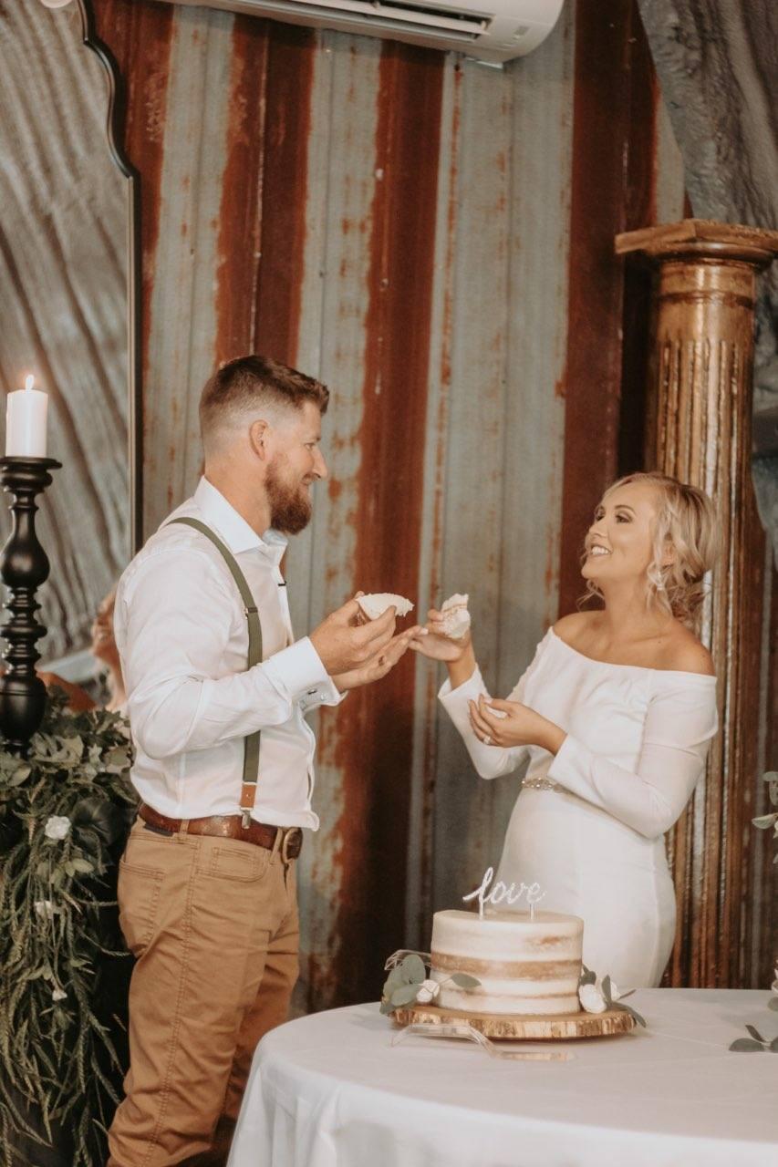 Ashley and Nolen Dale with wedding cake