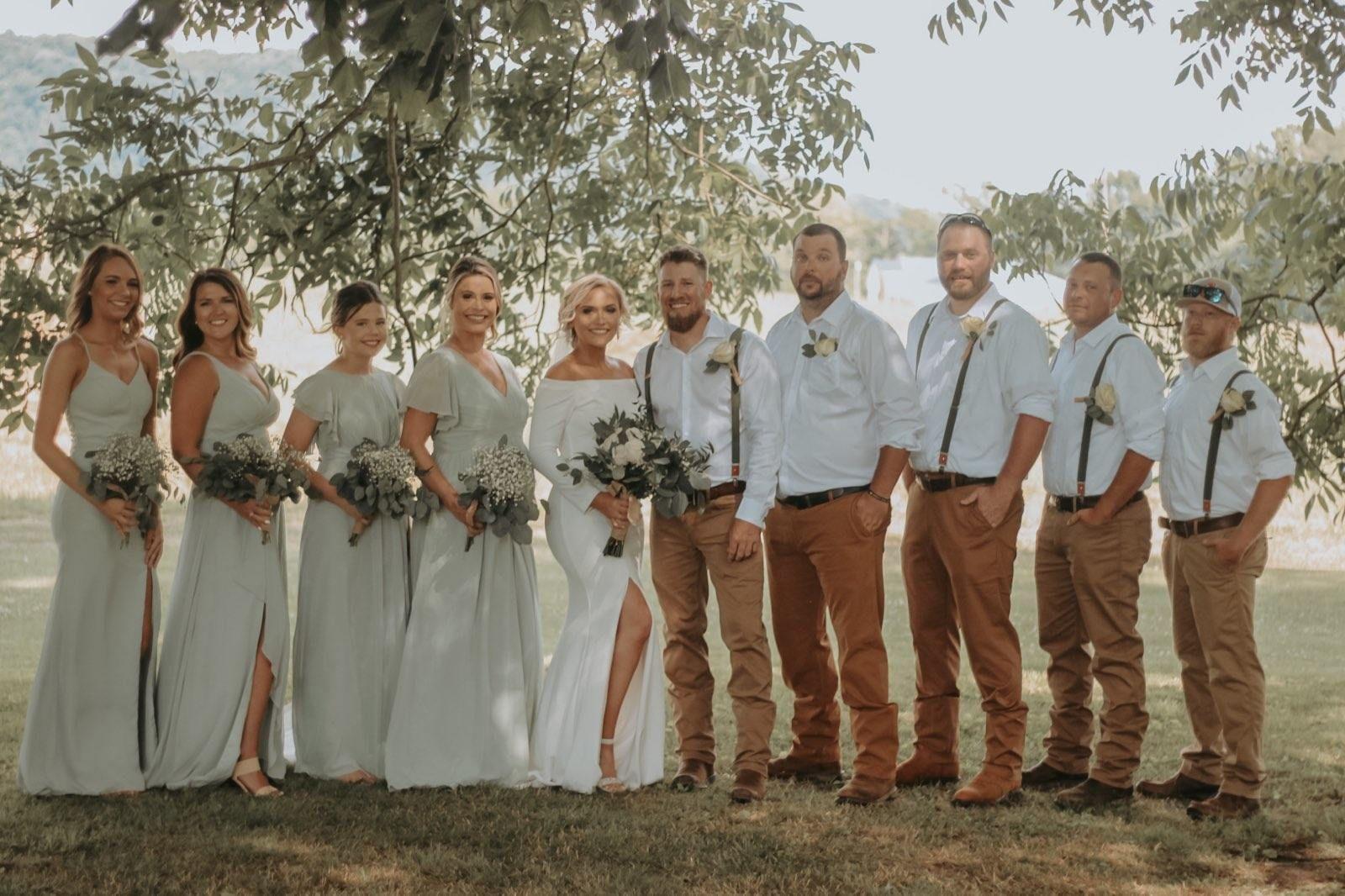 Ashley and Nolen Dale wedding party holding flowers by Ashley's friend Debbie