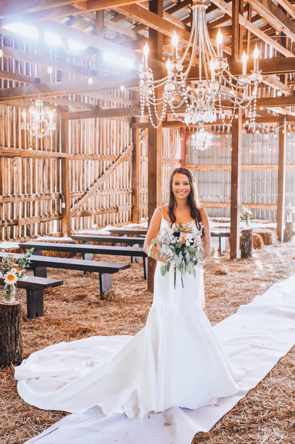 Photo of Bride in the Barn under the main chandelier
