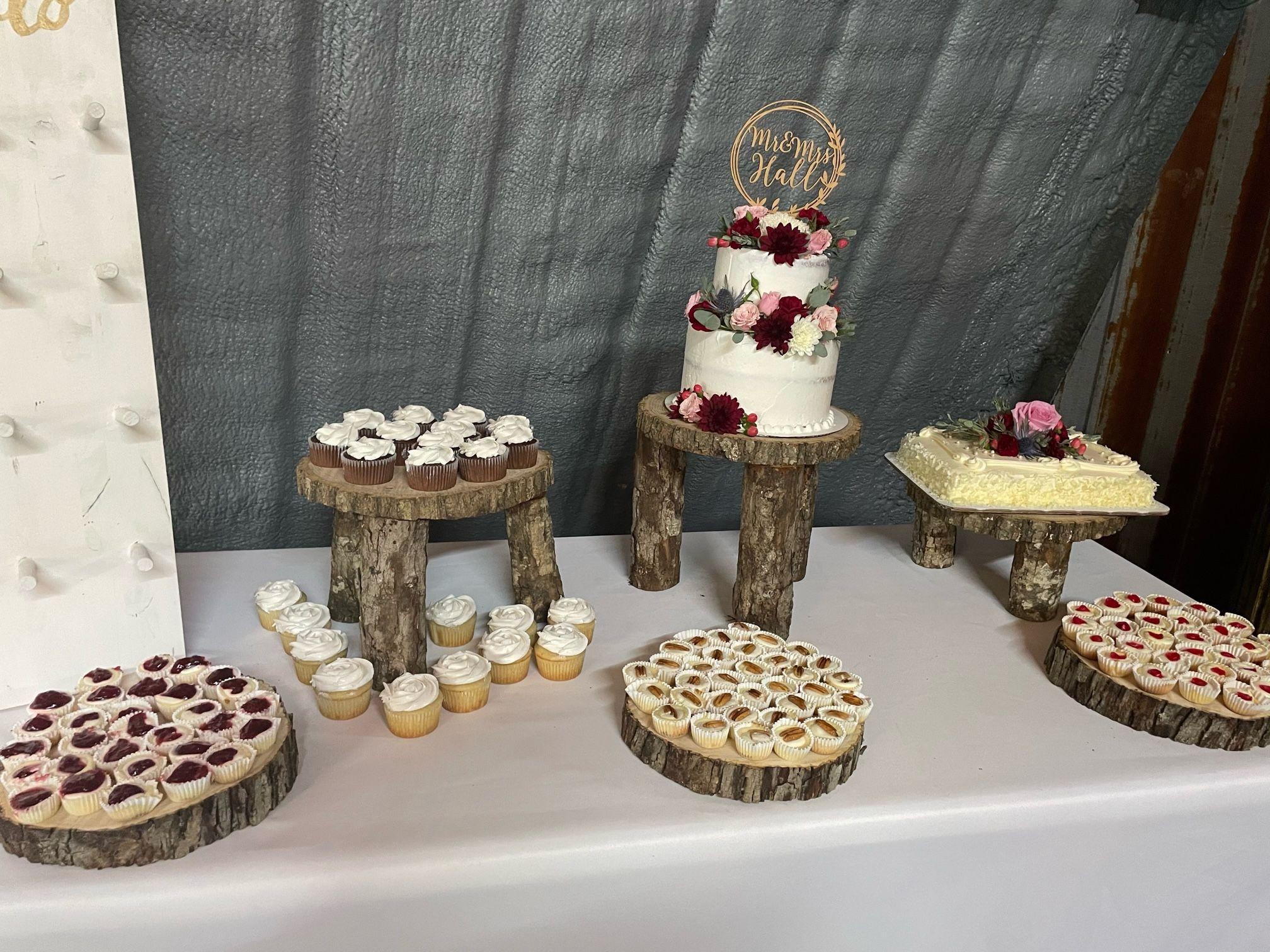 An array of desserts surround the 3-tier wedding care and groom's cake