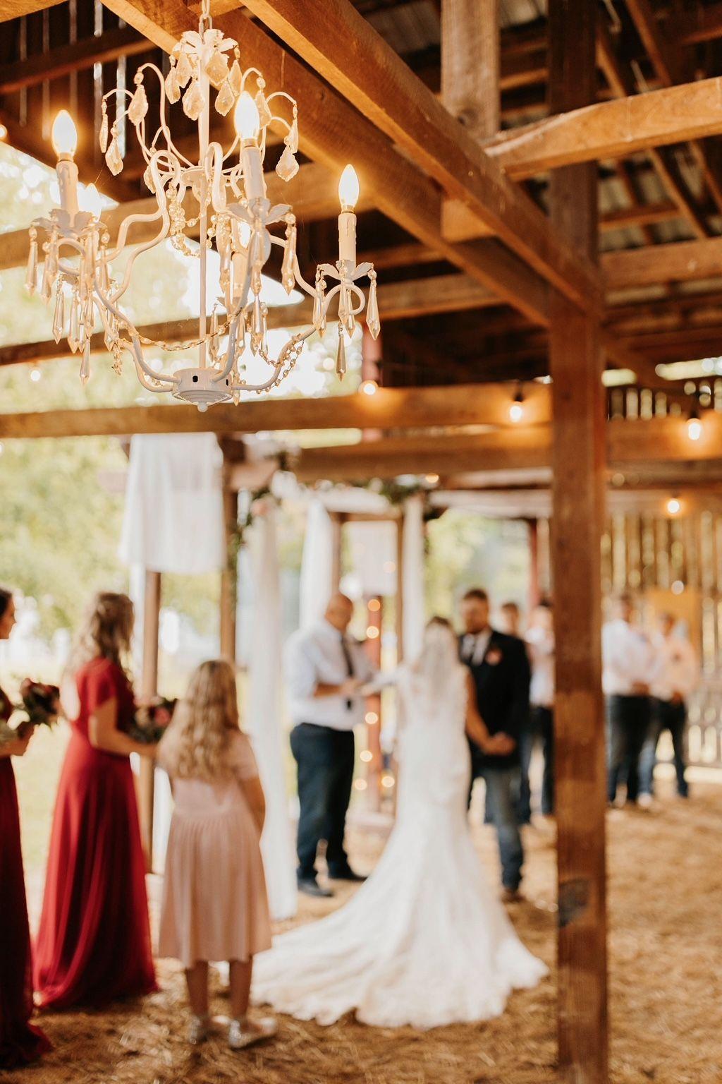 Photo of the wedding couple during the ceremony in the barn