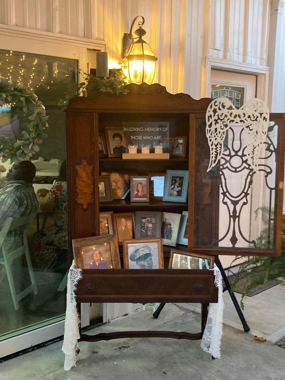 The couple decorated with an armour full of framed photos of family members