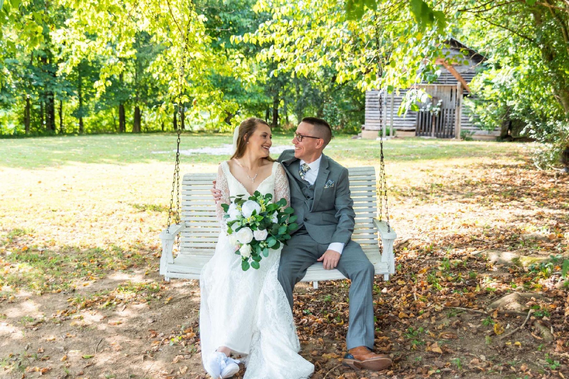 Jodi and Dustin on the swing at Hayes House. Jodi is holding her bouquet