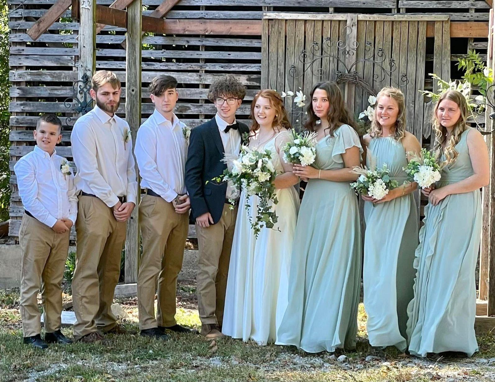 The bridal party in front of the historic outbuilding at Hayes House