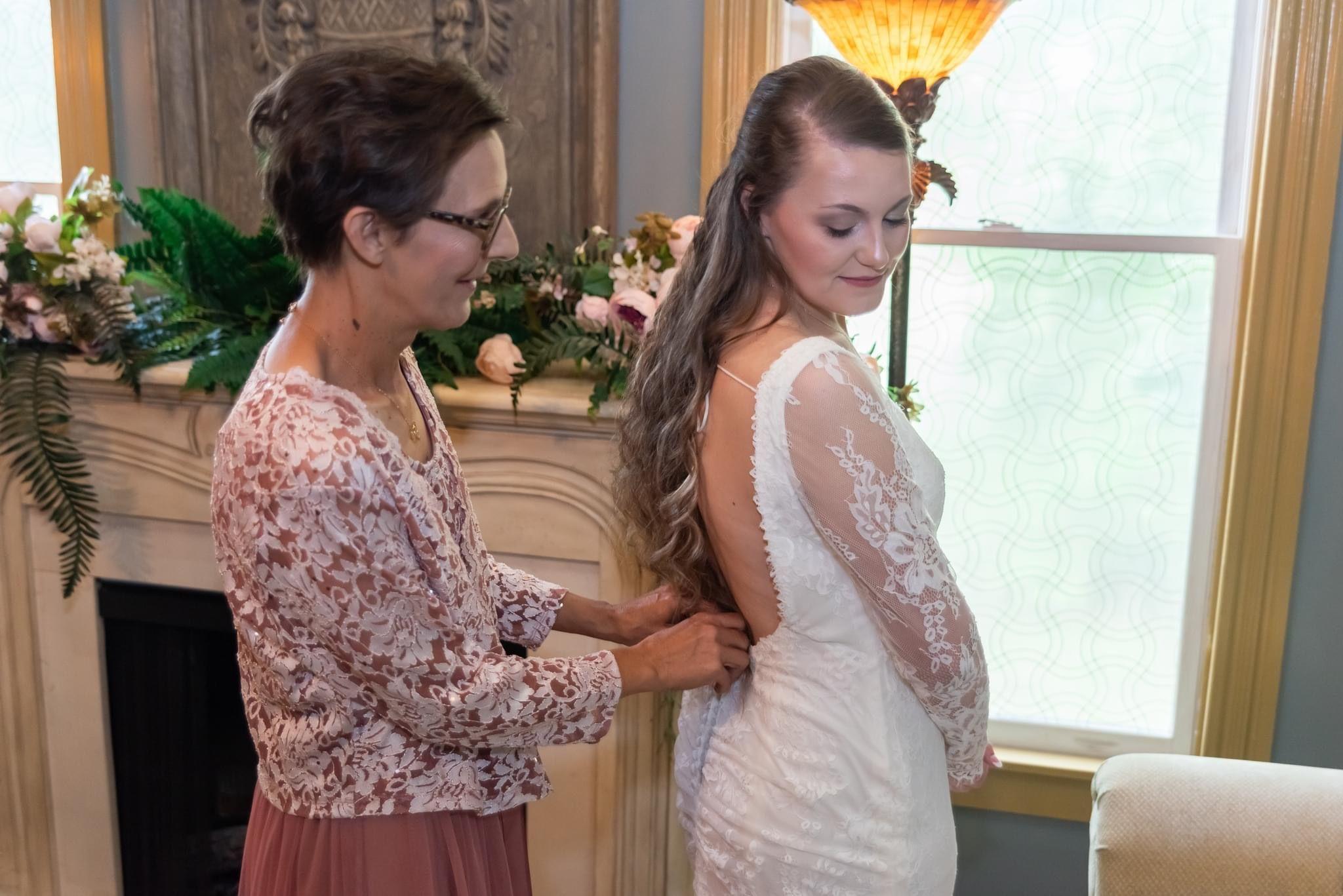 Jodi's wedding dress while backless has the beauty and warmth of lace full length sleeves