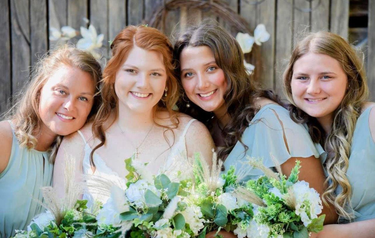 The bride with her attendants in soft green matching dresses