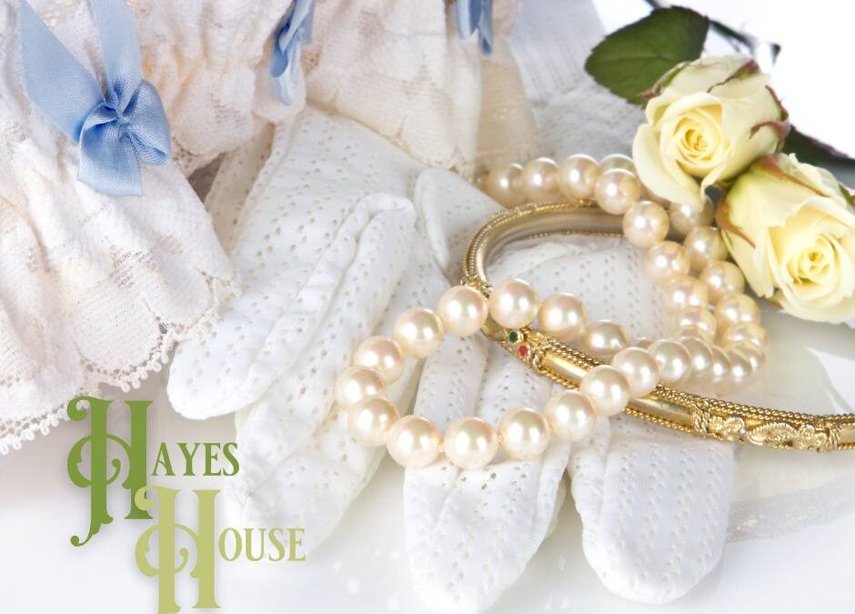 Photo of pearls, gloves with blue bows, roses