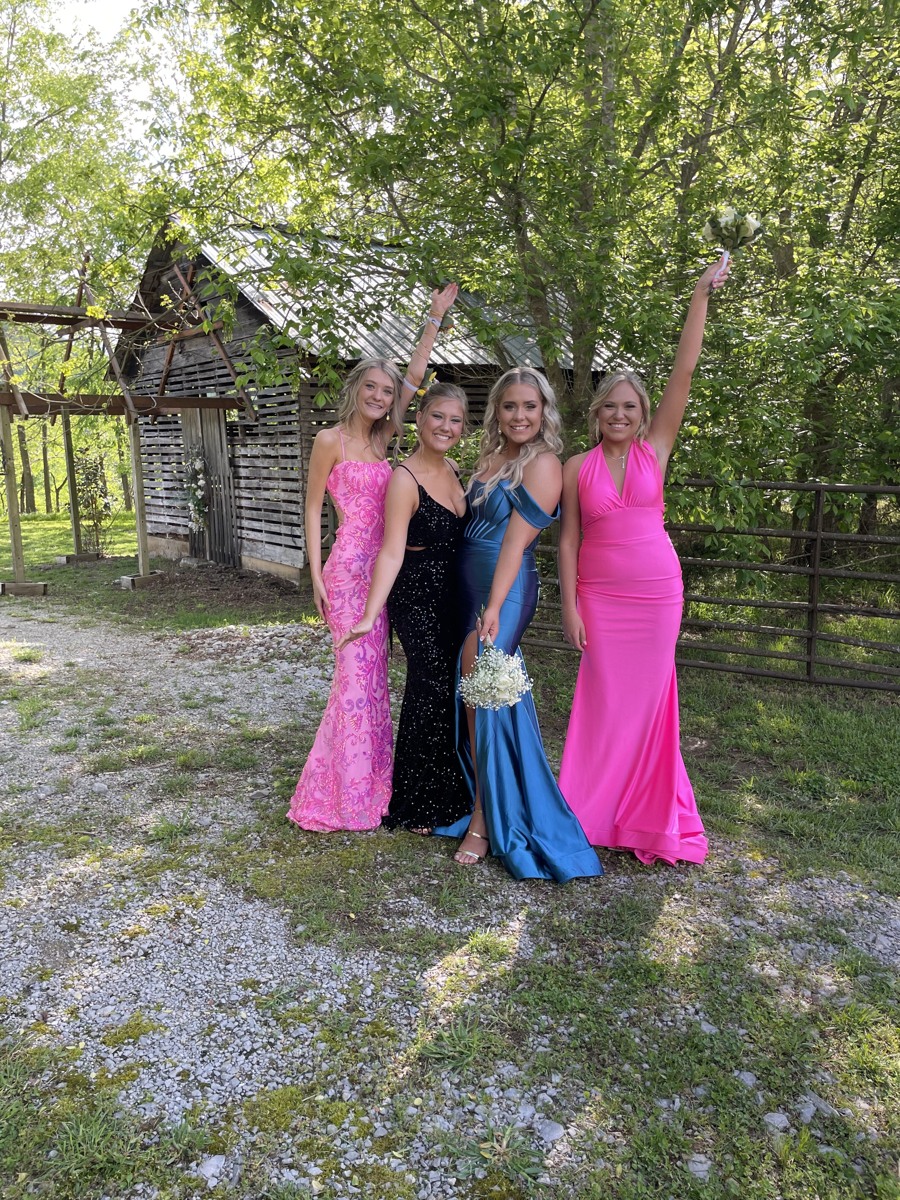 Four women dressed for Prom outside the historic outbuilding on the grounds of Hayes House